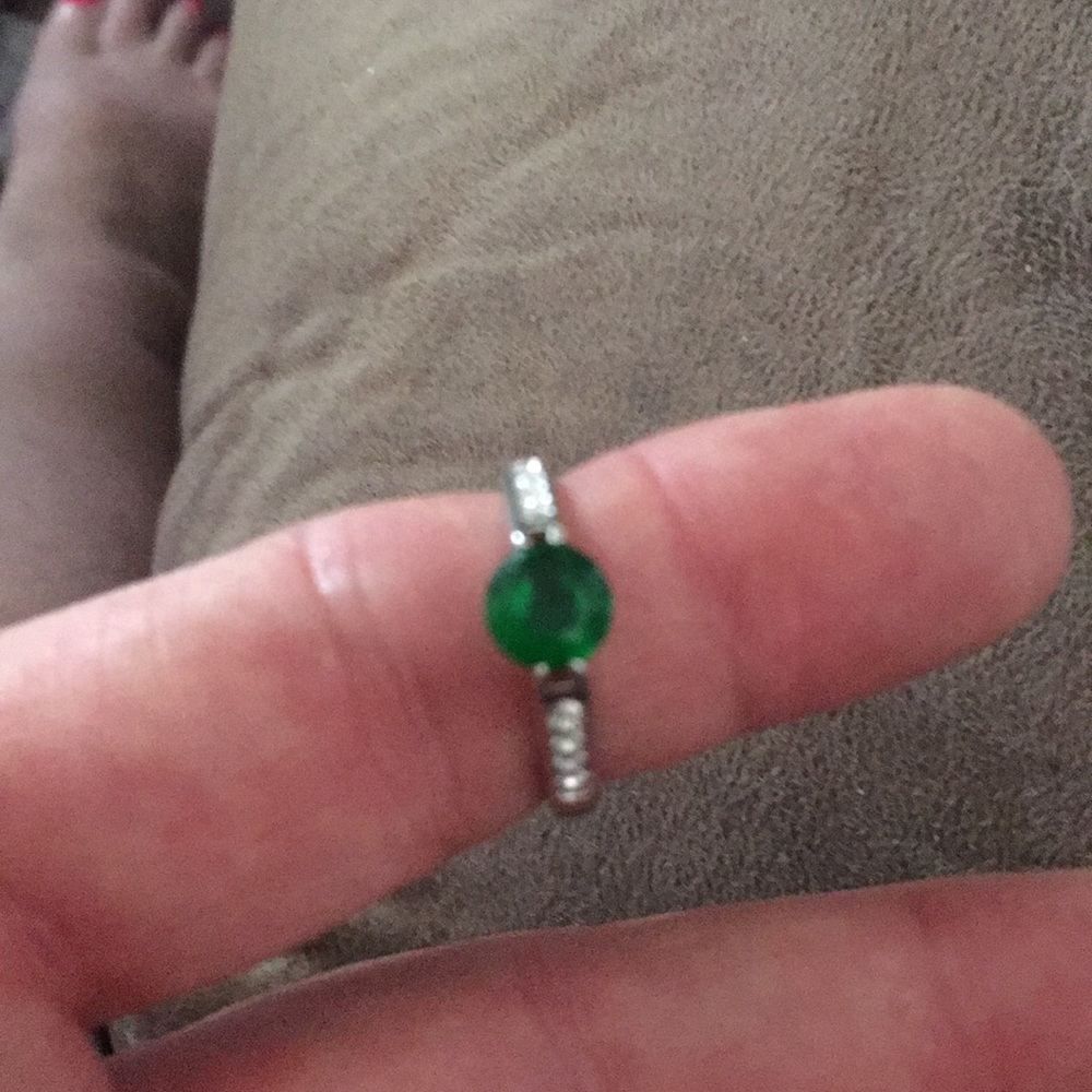 Silver ring with a deep green stone.